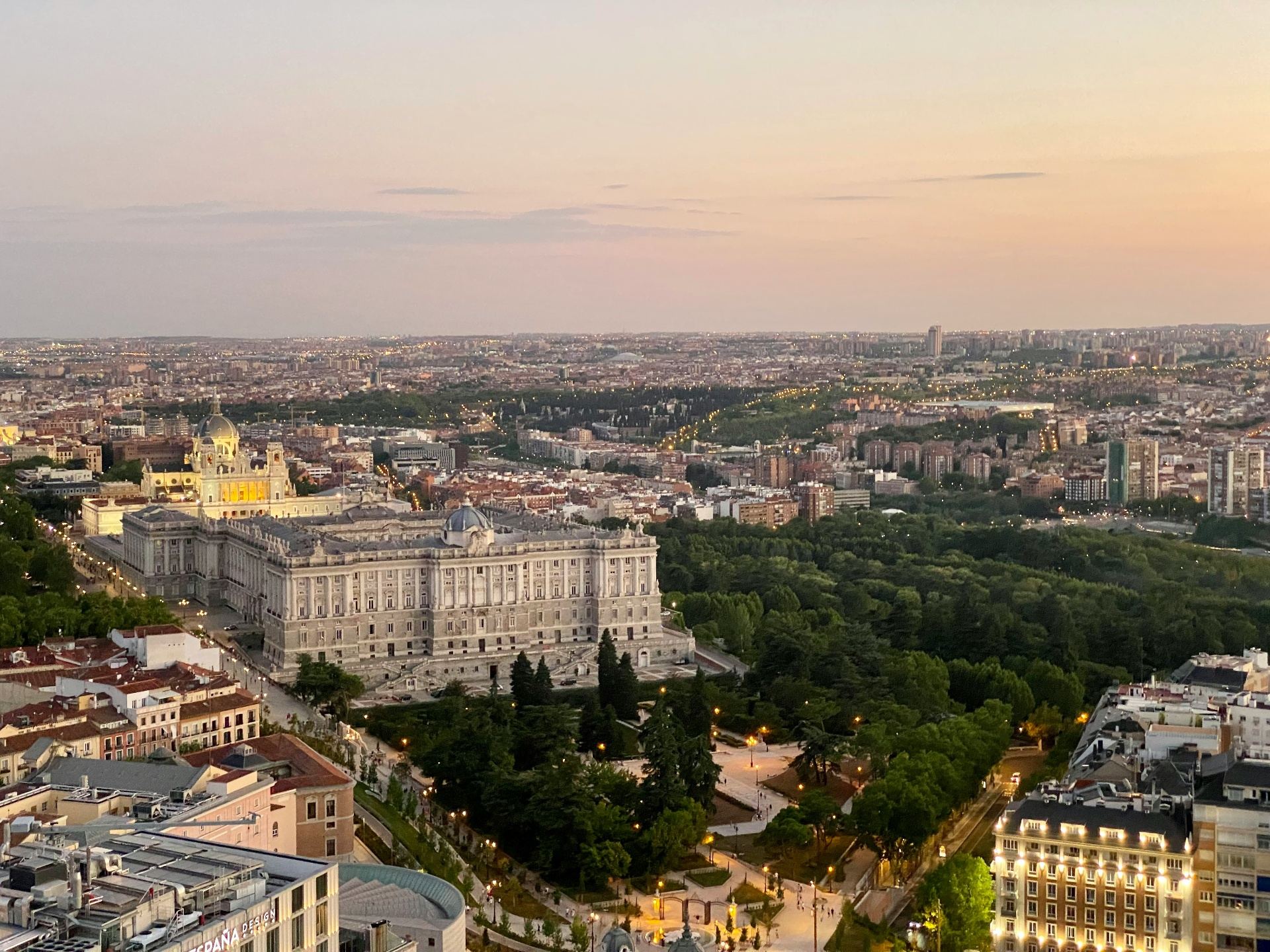 Panoramic aerial view of the Royal Palace of Madrid at sunset, with the city in the background